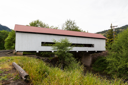 MYRTLE CREEK, OREGON - April 17, 2014: The historic Horse Creek Covered Bridge now spanning Myrtle Creek on a spring day in Myrtle Creek, OR on April 17, 2014. MYRTLE CREEK, OREGON - April 17, 2014: The historic Horse Creek Covered Bridge now spanning Myrtle Creek on a spring day in Myrtle Creek, OR on April 17, 2014.