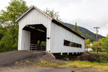 MYRTLE CREEK, OREGON - April 17, 2014: The historic Horse Creek Covered Bridge now spanning Myrtle Creek on a spring day in Myrtle Creek, OR on April 17, 2014. MYRTLE CREEK, OREGON - April 17, 2014: The historic Horse Creek Covered Bridge now spanning Myrtle Creek on a spring day in Myrtle Creek, OR on April 17, 2014.