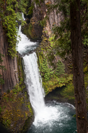 The North Umpqua River flowing over three tiers of columnar basalt rockto create Toketee Falls in Oregon.の写真素材