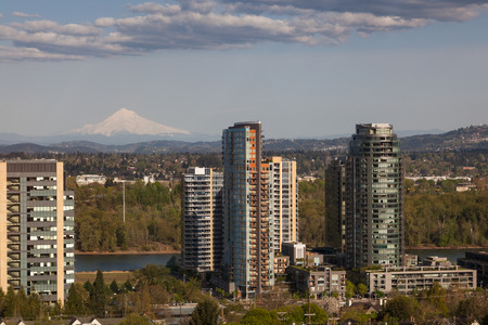 PORTLAND, OREGON - April 14, 2014:  A tram car view of city buildings, the Willamette River, and a distant Mount Hood in Portland, OR on April 14, 2014.のeditorial素材