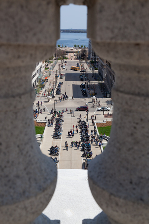 MADISON, WISCONSIN - May 10, 2014: Looking through a roof railing to a group of motorcycles parked at the capital building across from for motorcycle awareness month  in Madison, WI on May 10, 2014.のeditorial素材