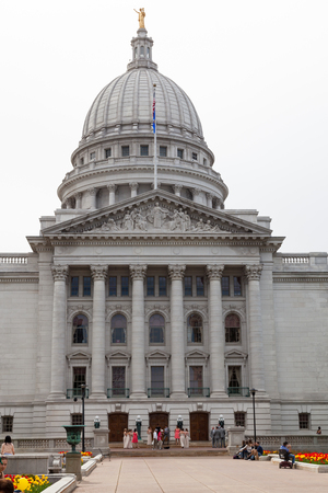 MADISON, WISCONSIN - May 10, 2014: A wedding party on the steps of the King Street entrance of the capital building  in Madison, WI on May 10, 2014.のeditorial素材