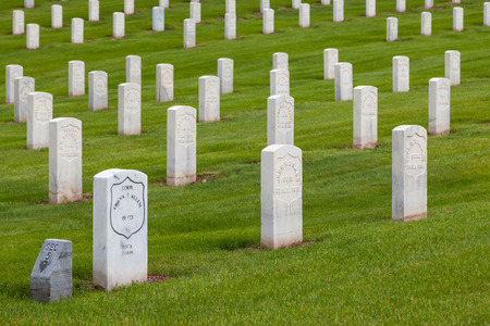 HOT SPRINGS, SOUTH DAKOTA - June 8, 2014:  A newer marble grave marker among older headstones for Civil War Soldiers in section 5 of the Hot Springs National Cemetery in Hot Springs, SD on June 8, 2014.のeditorial素材