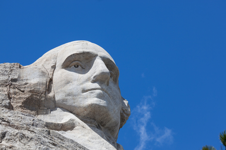 Looking up at a carved likeness of George Washington, one of four United States Presidents carved into granite at Mount Rushmore National Memorial in South Dakota.のeditorial素材
