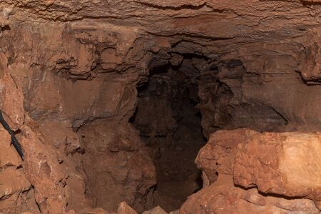 A shadowy passageway of a cave branch with a box work style ceiling inside of Wind Cave National Park, South Dakota.の写真素材
