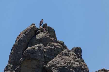 CUSTER, SOUTH DAKOTA - June13, 2014: A group of rock climbers reach the top of a large granite and quartz formation in the needles section of Custer State Park, SD on June 13, 2014.のeditorial素材