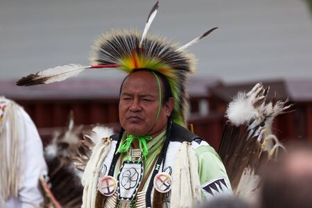 CUSTER, SOUTH DAKOTA - June15, 2014: A Native American man in tribe specific clothing giving a...