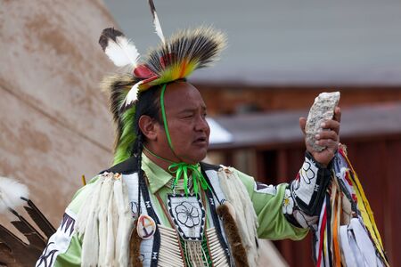 CUSTER, SOUTH DAKOTA - June15, 2014: A Native American man in tribe specific clothing giving a...