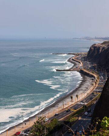 MIRAFLORES, LIMA, PERU - May 10, 2016: The shore of the Pacific Ocean with a busy highway under steep cliffs in the city of Lima, Peru on May 10 2016.のeditorial素材