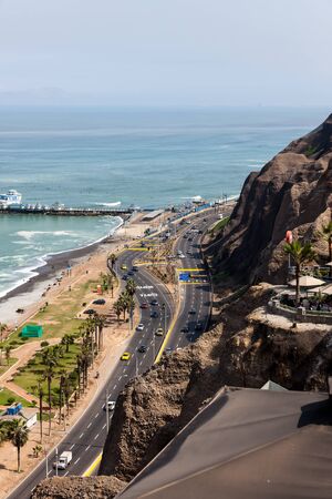 MIRAFLORES, LIMA, PERU - May 10, 2016: The shore of the Pacific Ocean with a busy highway under steep cliffs in the city of Lima, Peru on May 10 2016.のeditorial素材