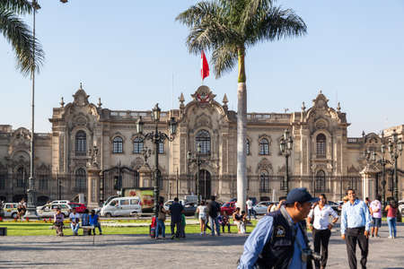 LIMA / PERU - May 10 2016: The Presidential Palace on The Plaza de Armas with people and traffic in Lima Peru.のeditorial素材