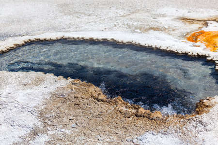 Ear Springs with blue water that goes deep underground and bubbles up at boiling temperatures in Yellowstone National Park, Wyoming.の写真素材