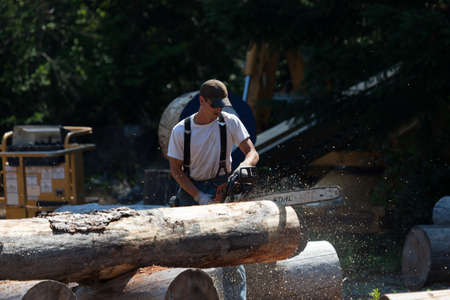 Prospect, Oregon / USA - August 16, 2014:  A man competes in a chainsaw event for fastest time at the Prospect Hillbilly Jamboree and Timber Carnival in Prospect, Oregon.のeditorial素材