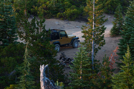 Red Blanket Mountain near Prospect,  Oregon / USA - September 8, 2014:  A gold Jeep Rubicon sits at the end of a dirt road surrounded by trees at the top of Red Blanket Mountain near Prospect, Oregon.のeditorial素材