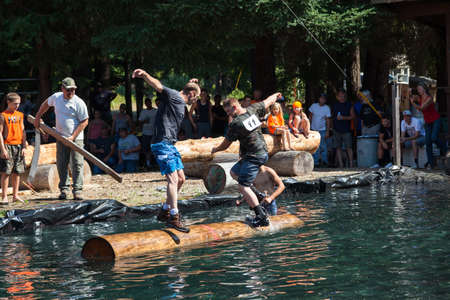Prospect, Oregon / USA - August 16, 2014: Two men compete in the log rolling skill event at the Prospect Hillbilly Jamboree and Timber Carnival in Prospect, Oregon.のeditorial素材
