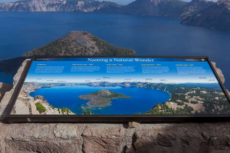 Crater Lake National Park,  Oregon / USA - September 18, 2014:  A metal sign at Watchman Lookout above Wizard Island tells the history of naming Crater Lake National Park, Oregon.のeditorial素材