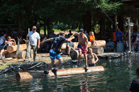 Prospect, Oregon / USA - August 16, 2014: Two men compete in the log rolling skill event at the Prospect Hillbilly Jamboree and Timber Carnival in Prospect, Oregon.のeditorial素材