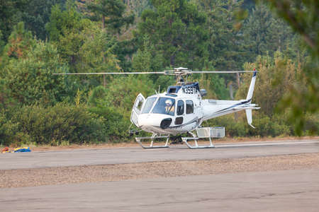 Prospect,  Oregon / USA - September 13, 2014:  A small rescue helicopter prepares to take off from the Prospect State Airport in support of the 790 Fire crew near Prospect, Oregon.のeditorial素材
