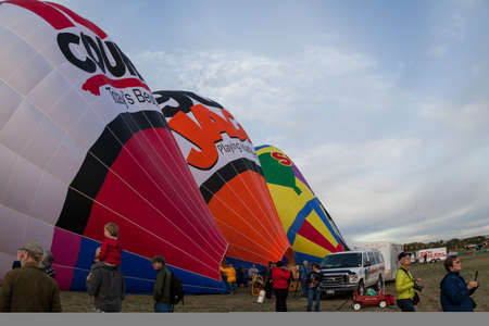 Albuquerque,  New Mexico / USA - October 8, 2014:  People walk around on a large field as hot air balloons are inflated for take off at the Balloon Fiesta in Albuquerque, NM.のeditorial素材