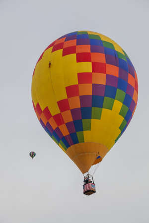 Albuquerque,  New Mexico / USA - October 8, 2014:  Two hot air balloons raising up into a cloudy morning sky at the Balloon Fiesta in Albuquerque, NM.のeditorial素材