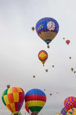 Albuquerque,  New Mexico / USA - October 8, 2014:  Several hot air balloons raising up into a cloudy morning sky at the Balloon Fiesta in Albuquerque, NM.のeditorial素材