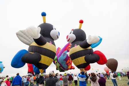 Albuquerque,  New Mexico / USA - October 8, 2014:  Two bee shaped balloons prepare to take off among the large crowds at the Balloon Fiesta in Albuquerque, NM.のeditorial素材