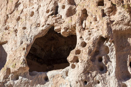 Sandstone walls in Frijoles Canyon that have been carved out by the Pueblo people for dwellings in Bandelier National Monument, New Mexico.の写真素材
