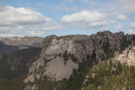 An aerial view of Mount Rushmore Narional Memorial showing the carved faces of past Presidents George Washington, Thomas Jefferson, Theodore Roosevelt, and Abraham Lincoln.のeditorial素材