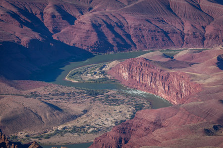 Detailed section of the Colorado River with rapids as it cuts a path through the red sandstone rocks of the Grand Canyon in Arizona.の写真素材