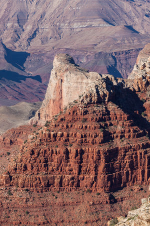 A cute of orange sandstone rocks inside of the Grand Canyon that has been eroded over the years to create steep cliffs.の写真素材