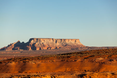 A large eroding sandstone mountain with late afternoon sunlight located close to Lake Powell and Page, Arizona.の写真素材