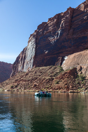 A group of unrecognizable people on a rubber raft floating on the Colorado River in Glen Canyon on a sunny day.の写真素材