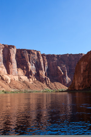 Rafting on a calm area of the Colorado River through Horseshoe Bend in Glen Canyon on a clear sunny day.の写真素材