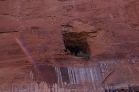 A window opening carved into a wall of ancient sandstone to provide air ventilation for a tunnel road that has been carved through the red rock.の写真素材