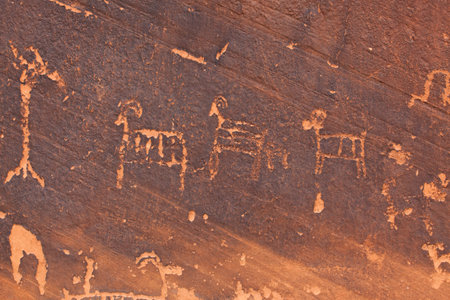 Ancient petroglyphs carved into the sandstone walls of Glen Canyon along the Colorado River near Page, Arizona.の写真素材
