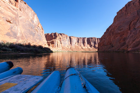 Rafting on a calm area of the Colorado River through Horseshoe Bend in Glen Canyon on a clear sunny day.の写真素材