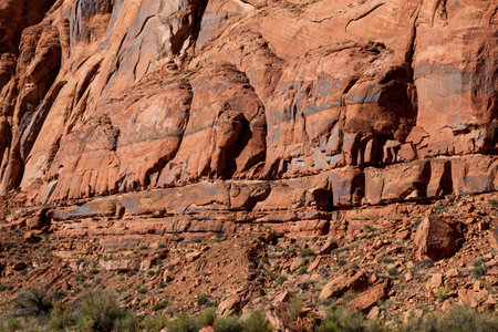 Ancient sandstone walls tower over the Colorado River in Glen Canyon showing interesting geology of years past.の写真素材