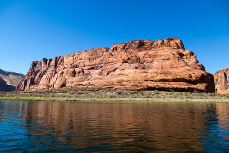 Rafting on a calm area of the Colorado River through Horseshoe Bend in Glen Canyon on a clear sunny day.の写真素材