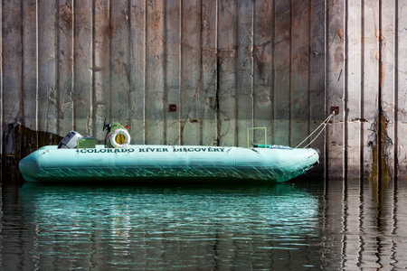 Glen Canyon, Arizona / USA - October 30, 2014:  A green rubber raft owned by the Colorado River Discovery company is stored on the Colorado River near Page, Arizona.のeditorial素材