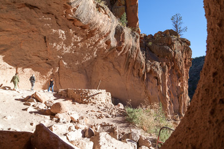 Bandelier National Monument,  New Mexico / USA - October 13, 2014:  Tourist walking on the pathway inside of ancient rock dwellings on a sunny day in Bandelier National Monument, New Mexico.のeditorial素材
