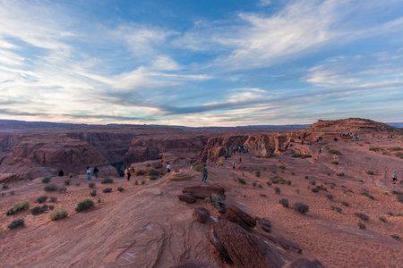 Horseshoe Bend, Arizona / USA - October 30, 2014:  People lined up at sunset on the steep canyon cliffs that overlook Horseshoe Bend on the Colorado River near Page, Arizona.のeditorial素材