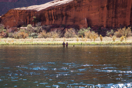 Horseshoe Bend, Arizona / USA - October 30, 2014:  A couple and their dog wading into the Colorado River to fish at Horseshoe Bend in Glen Canyon near Page, Arizona.のeditorial素材