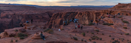 Horseshoe Bend, Arizona / USA - October 30, 2014:  People lined up at sunset on the steep canyon cliffs that overlook Horseshoe Bend on the Colorado River near Page, Arizona.のeditorial素材