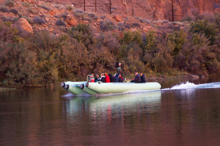 Glen Canyon, Arizona / USA - October 30, 2014:  A green rubber raft owned by the Colorado River Discovery company taking people on a tour of Glen Canyon and the Colorado River.のeditorial素材