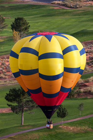 Page, Arizona / USA - October 31, 2014:  A participant in the Lake Powell Balloon Regatta floats over the Lake Powell National Golf Course during the annual festival in Page, Arizona.のeditorial素材