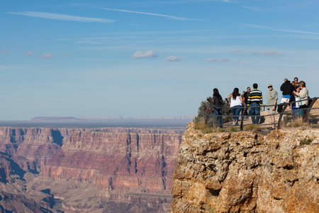 Grand Canyon, Arizona / USA - October 27, 2014:  Tourists standing at a view point overlooking the colorful sandstone walls of the Grand Canyon and Colorado River in Northern Arizona.のeditorial素材