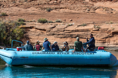 Glen Canyon, Arizona / USA - October 30, 2014:  A blue rubber raft owned by the Colorado River Discovery company taking people on a tour of Glen Canyon and the Colorado River.のeditorial素材