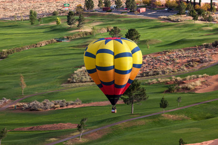 Page, Arizona / USA - October 31, 2014:  A participant in the Lake Powell Balloon Regatta floats over the Lake Powell National Golf Course during the annual festival in Page, Arizona.のeditorial素材