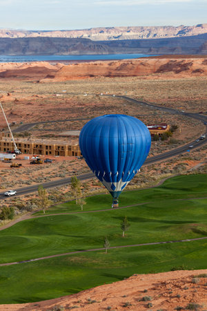 Page, Arizona / USA - October 31, 2014:  A participant in the Lake Powell Balloon Regatta floats over the Lake Powell National Golf Course during the annual festival in Page, Arizona.のeditorial素材