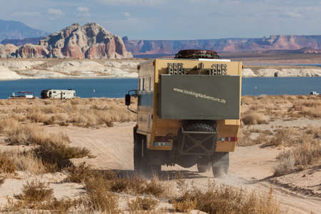 Lake Powell, Utah, USA - October 31, 2014:  An extreme off-road camping vehicle drives on a sand path near the shore of Lake Powell in Utah's Grand Staircase Escalante National Monument.のeditorial素材